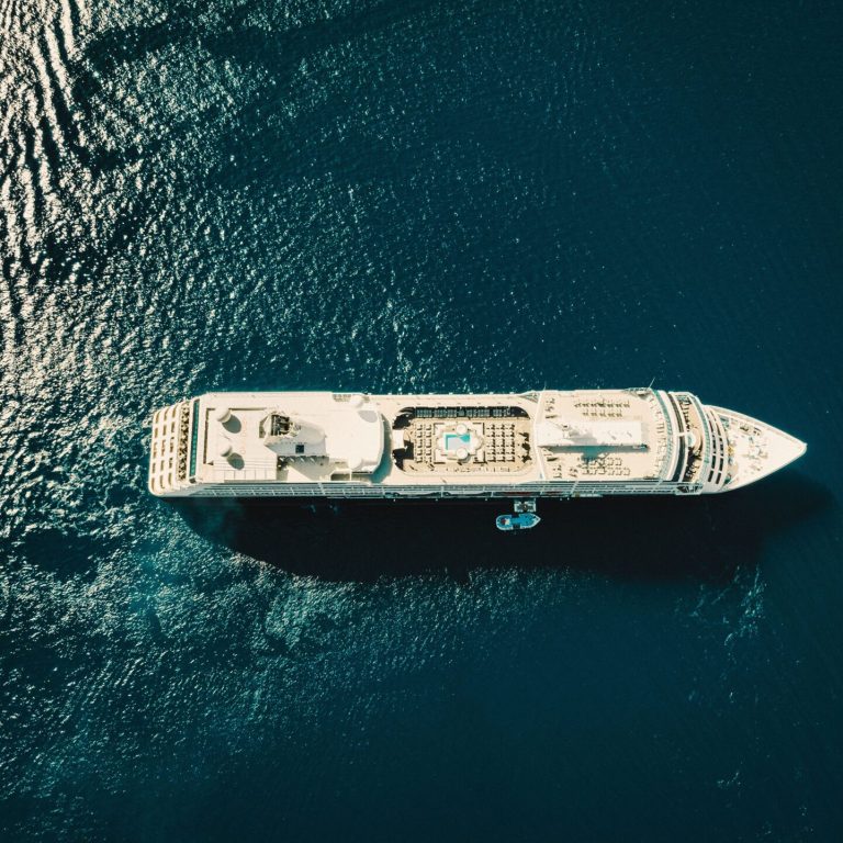 A stunning aerial view of a cruise ship sailing through the deep blue ocean.